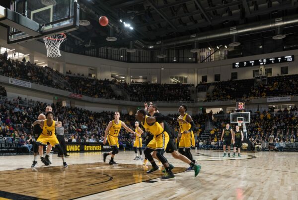 UMBC retrievers playing basketball in UMBC arena