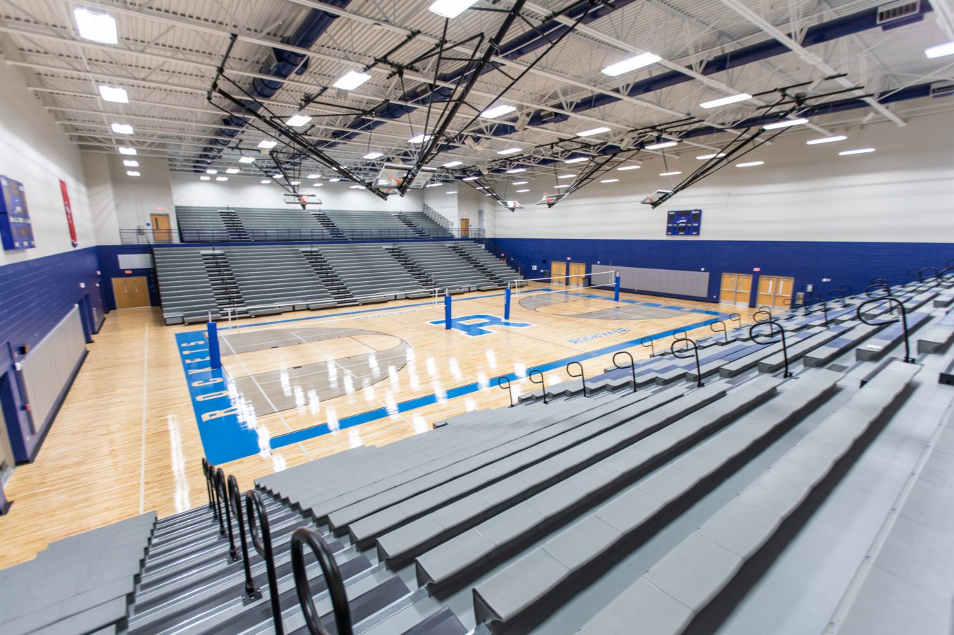 Gymnasium with basketball court and bleacher seating