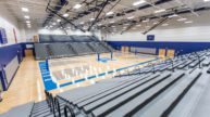 Gymnasium with basketball court and bleacher seating