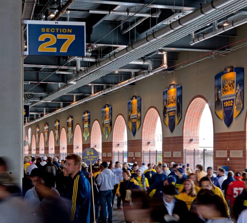 Michigan football fans entering section 27 from interior concourse