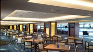 Dining tables and seats in interior concourse club area