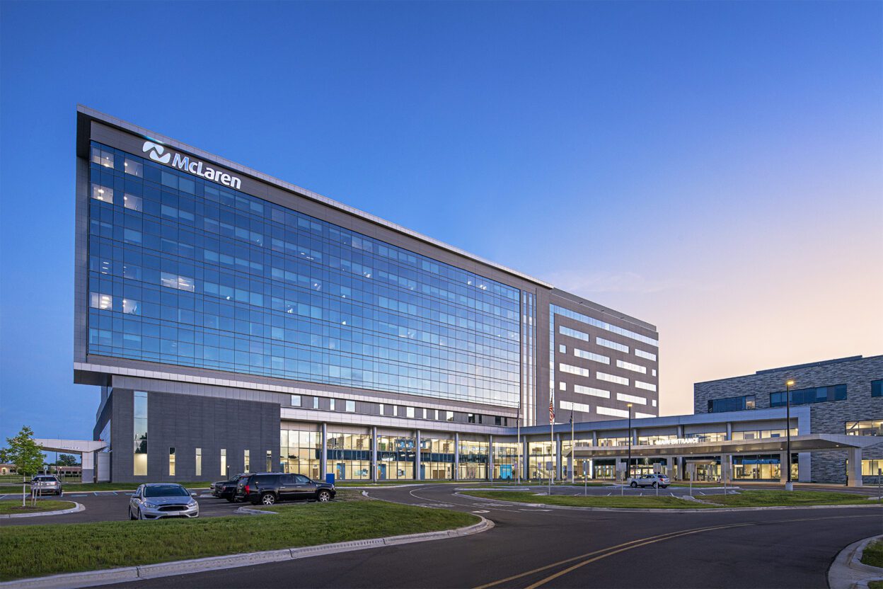 Hospital building during sunset with windows illuminated