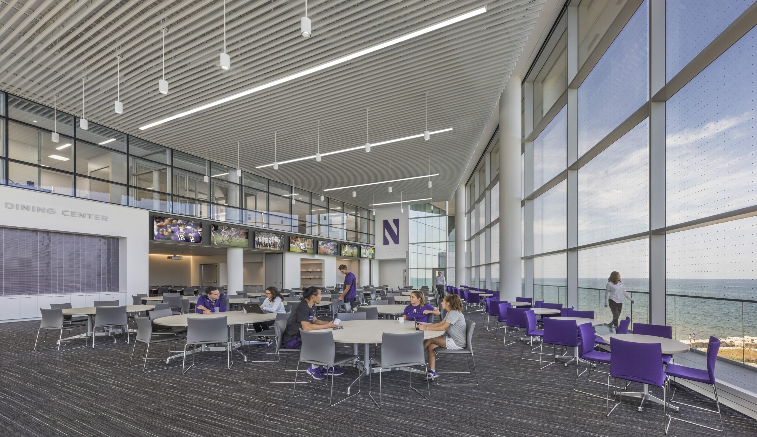 Tables and purple chairs in dining facility