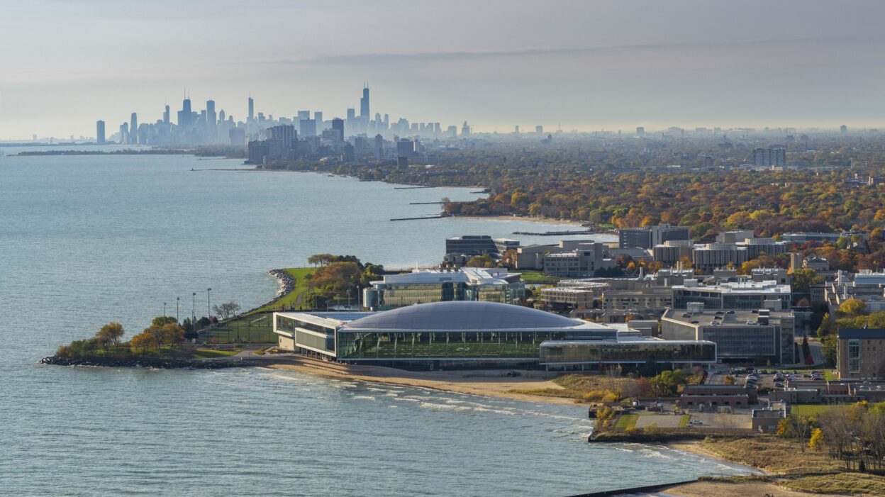 Aerial view of athletic center against Chicago skyline