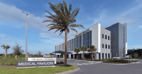 Exterior view of the medical pavilion building with palm trees