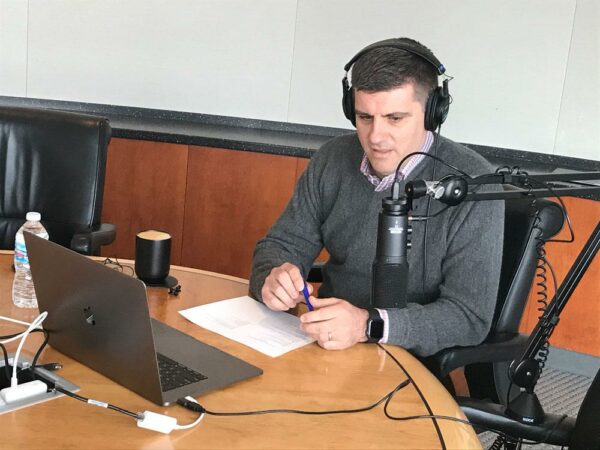 CEO Ryan Maibach talking into podcast microphone
