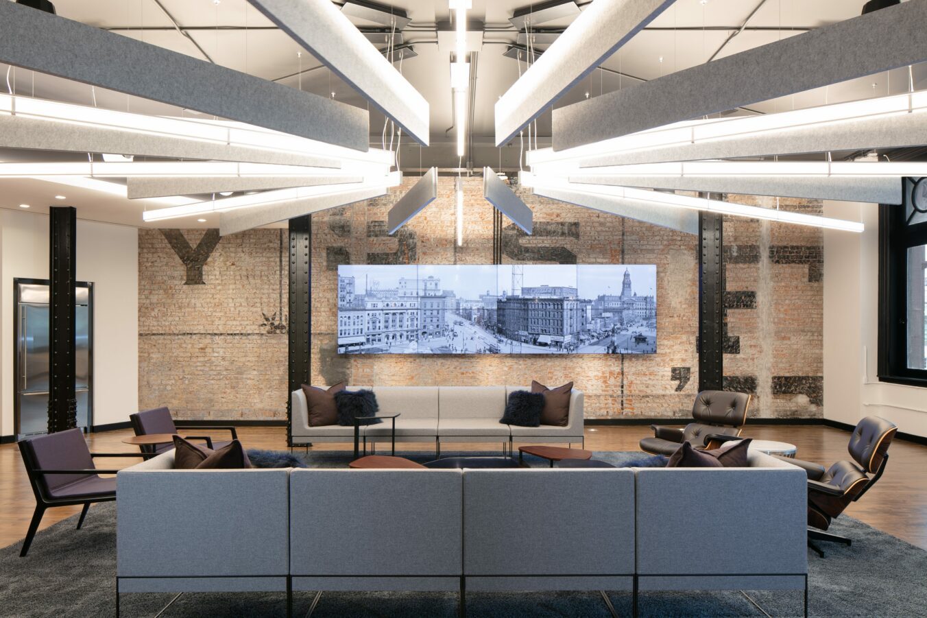 commercial office renovation common space with couches and padded chairs