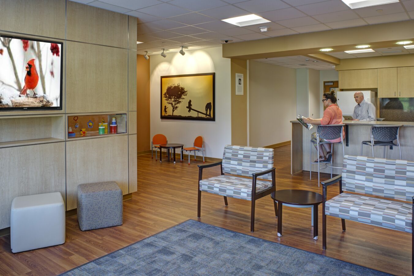 Couple standing at kitchen bar area in family lounge