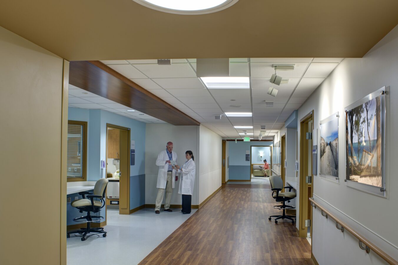 Doctors having discussion in hallway of patient rooms
