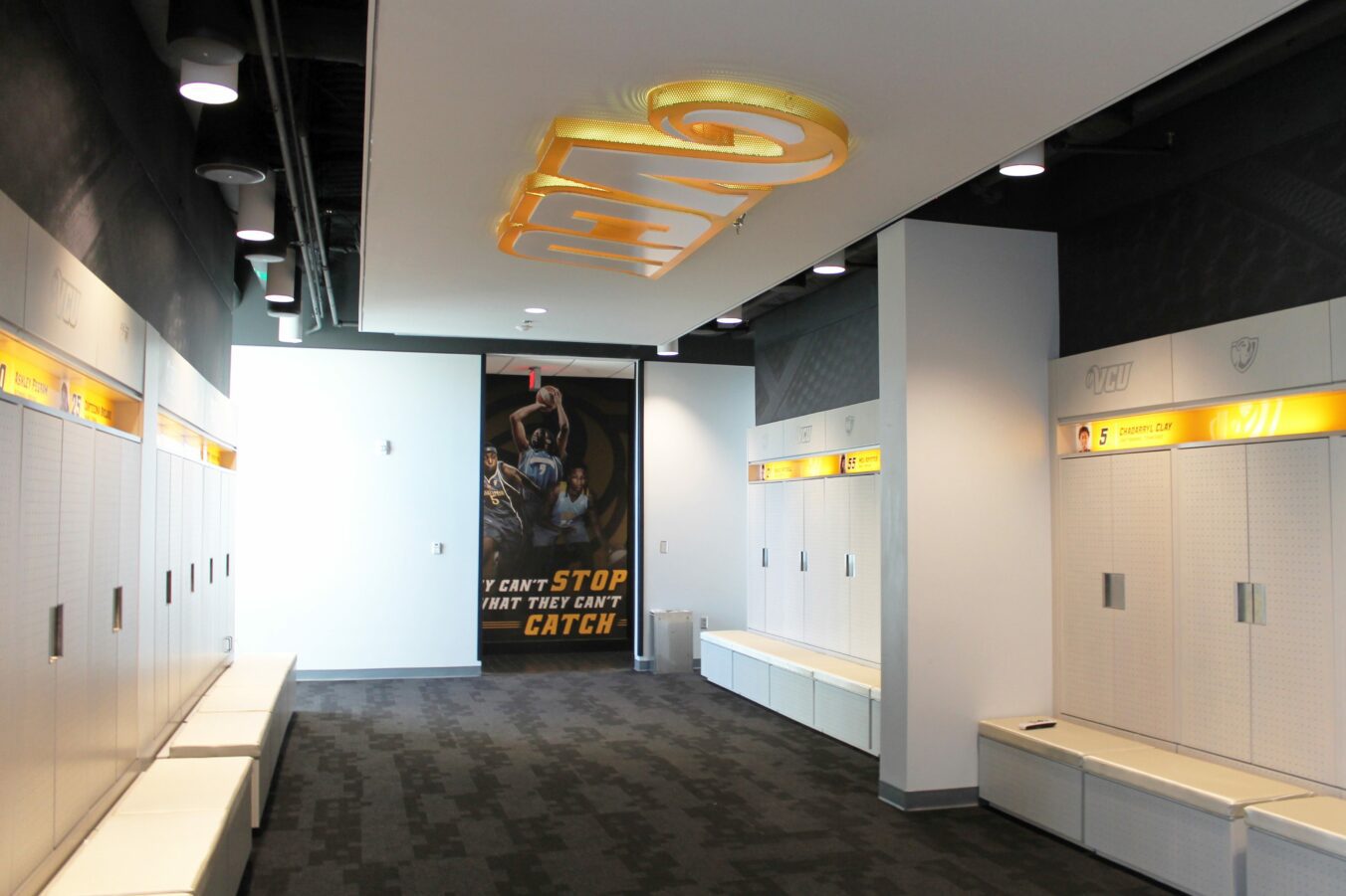 Locker room with player's names above white lockers
