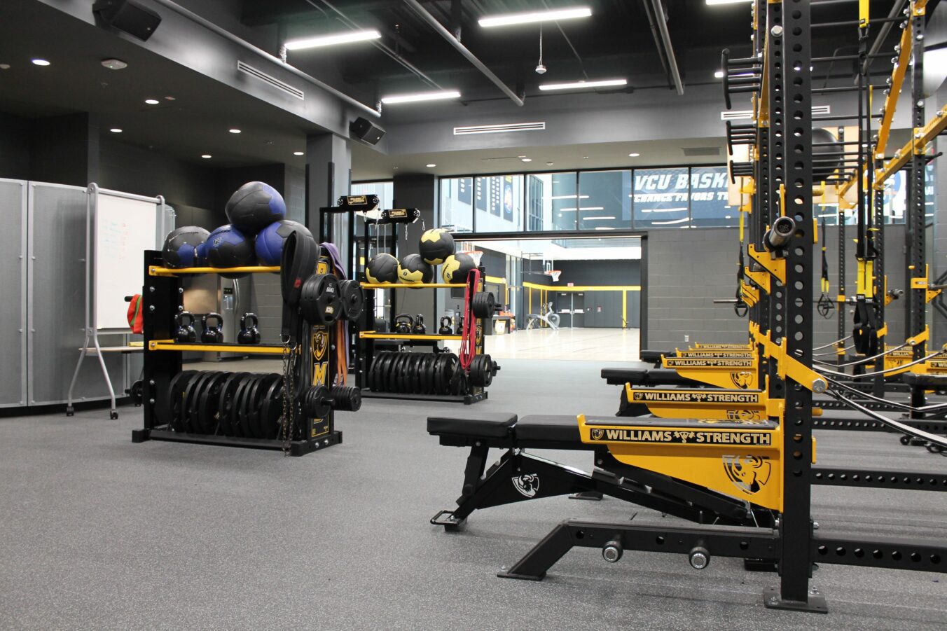 VCU Athletics free weights and exercise equipment in training room