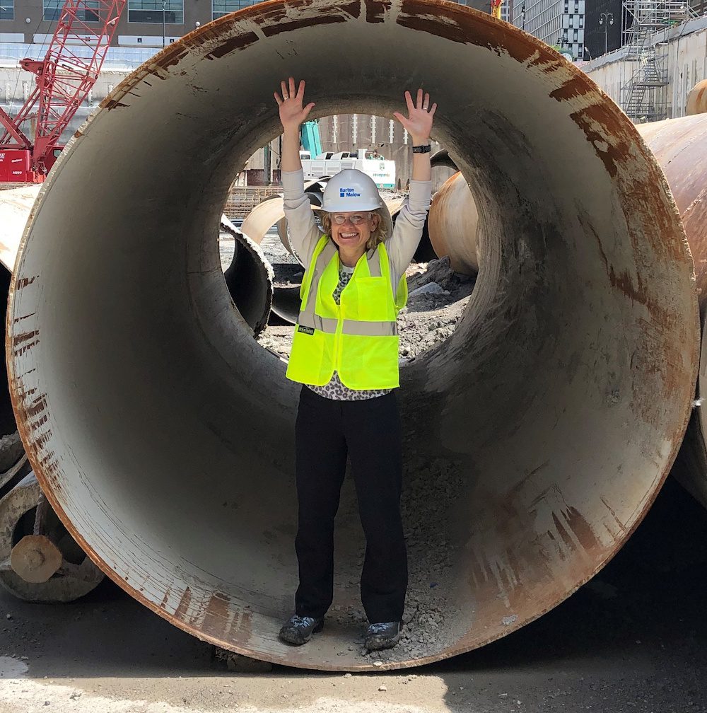 Female Lean Director Jill Katic standing in steel caisson