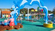 Kids splash at the colorful splash pad and water slides