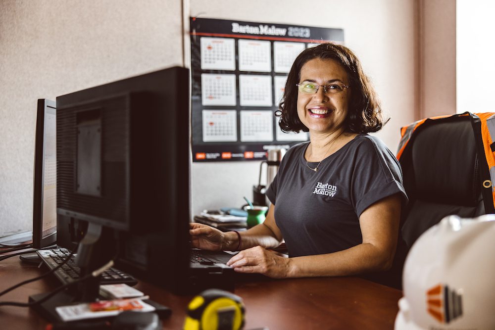 Senior Cost Analyst Olga Dunham sitting at her desk during Women in Construction at the South Florida Baptist Hospital project site