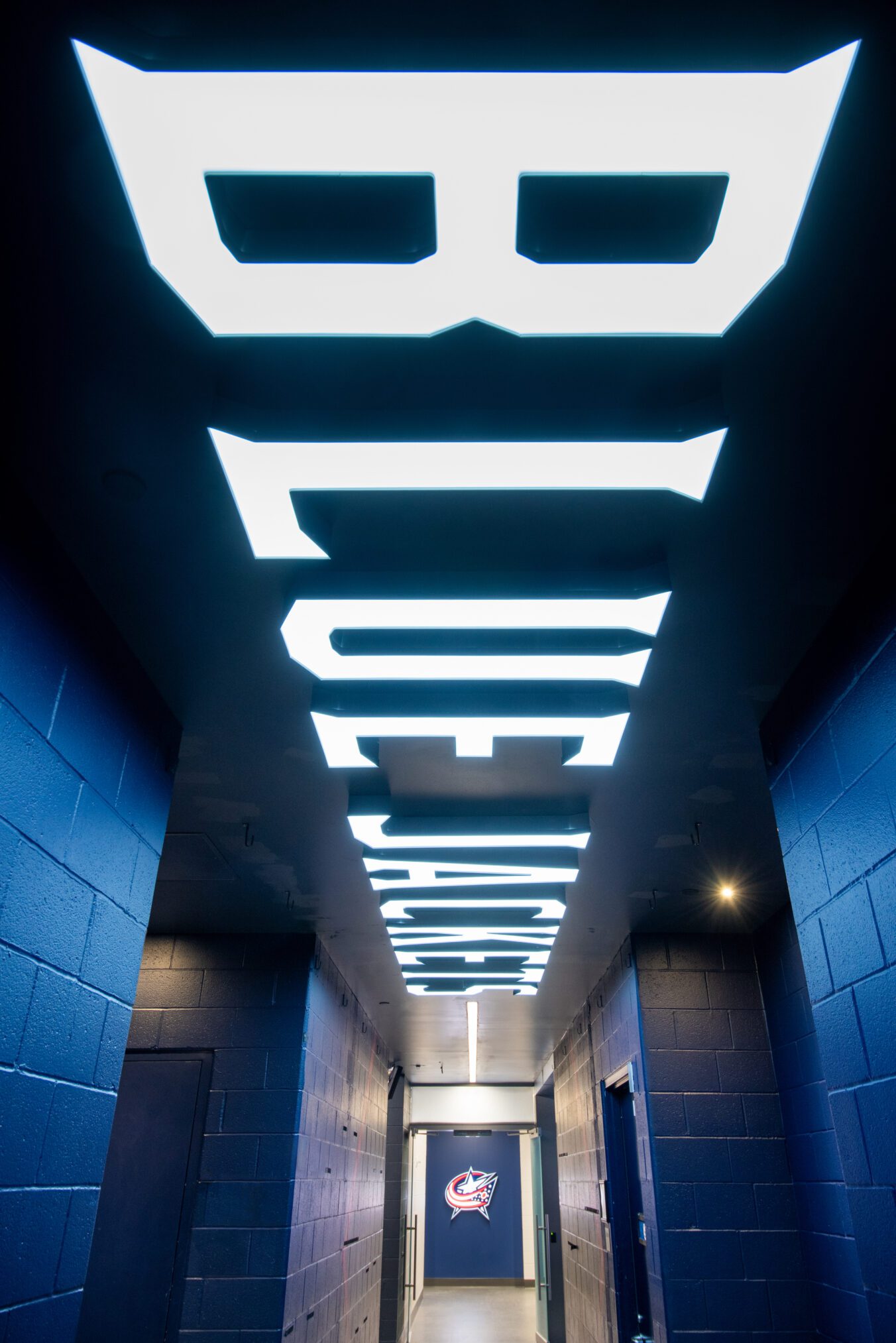 Columbus Blue Jackets NHL locker room renovation - LED Blue Jackets lighting across the ceiling of a hallway