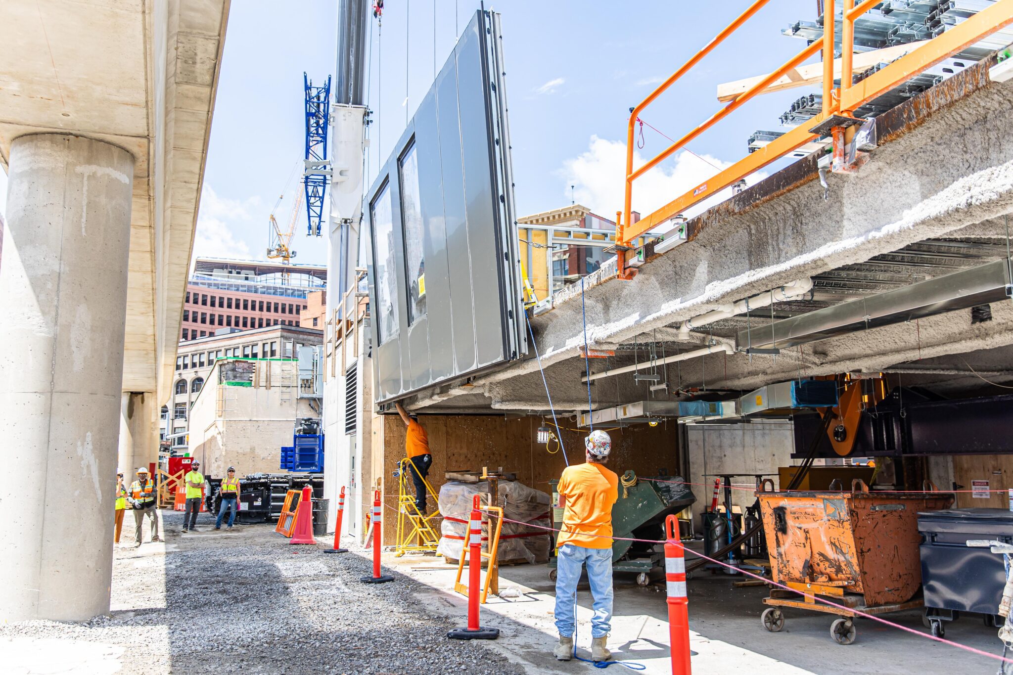 Construction Worker puts curtainwall into place from the ground, removing the need for fall protection.