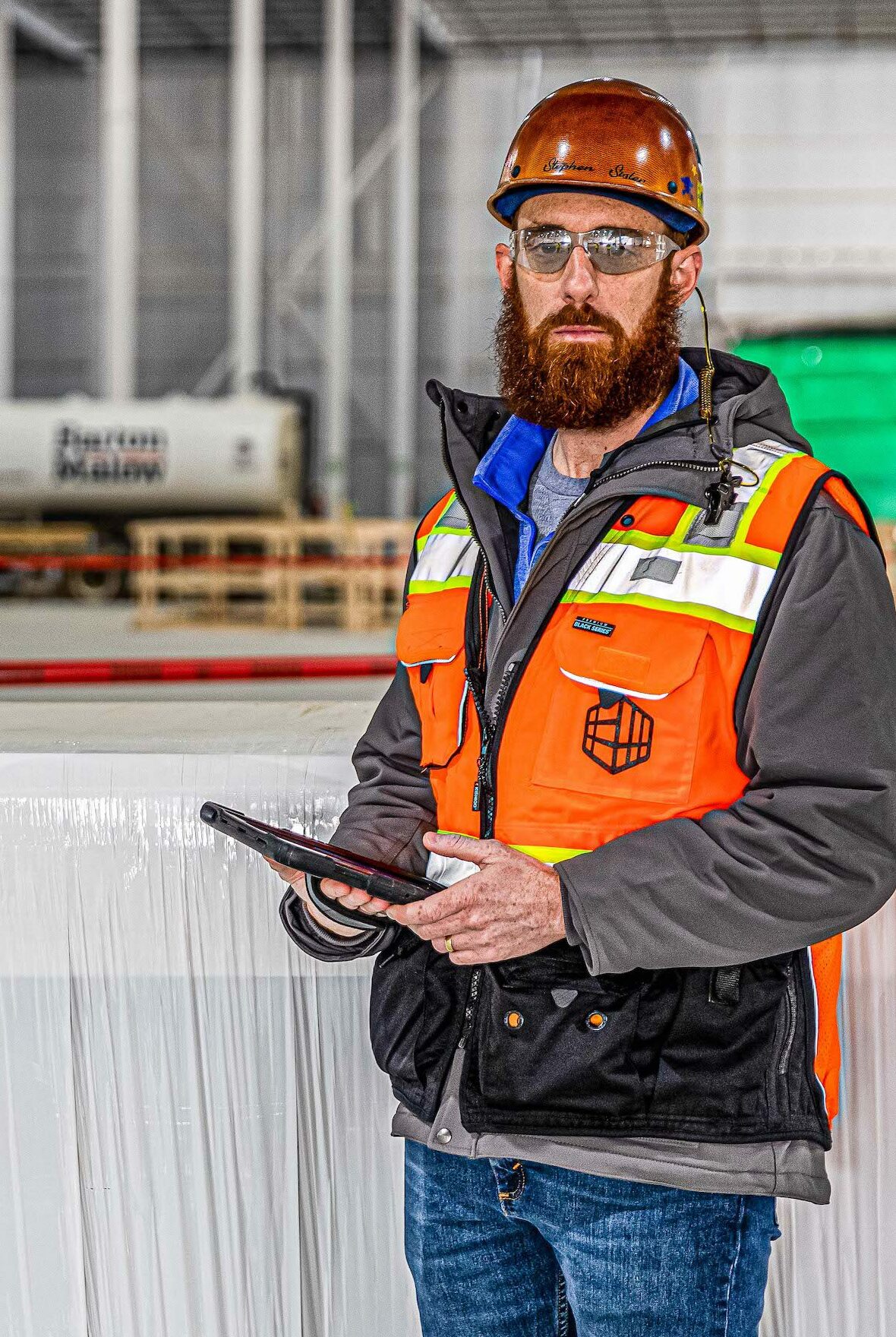 Construction Safety manager Steve Sisler standing with iPad on jobsite