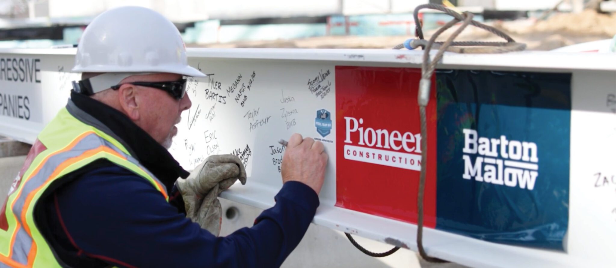 Man signing steel beam